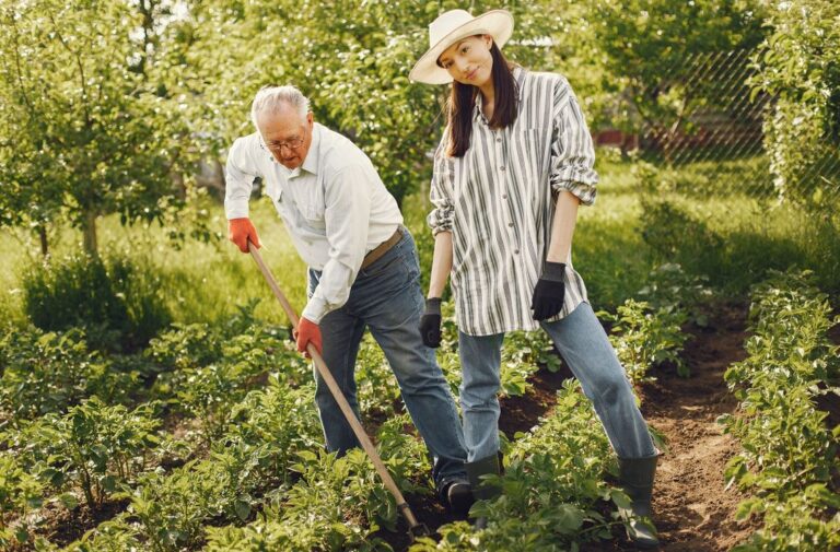 portrait senior man hat gardening with granddaugher2